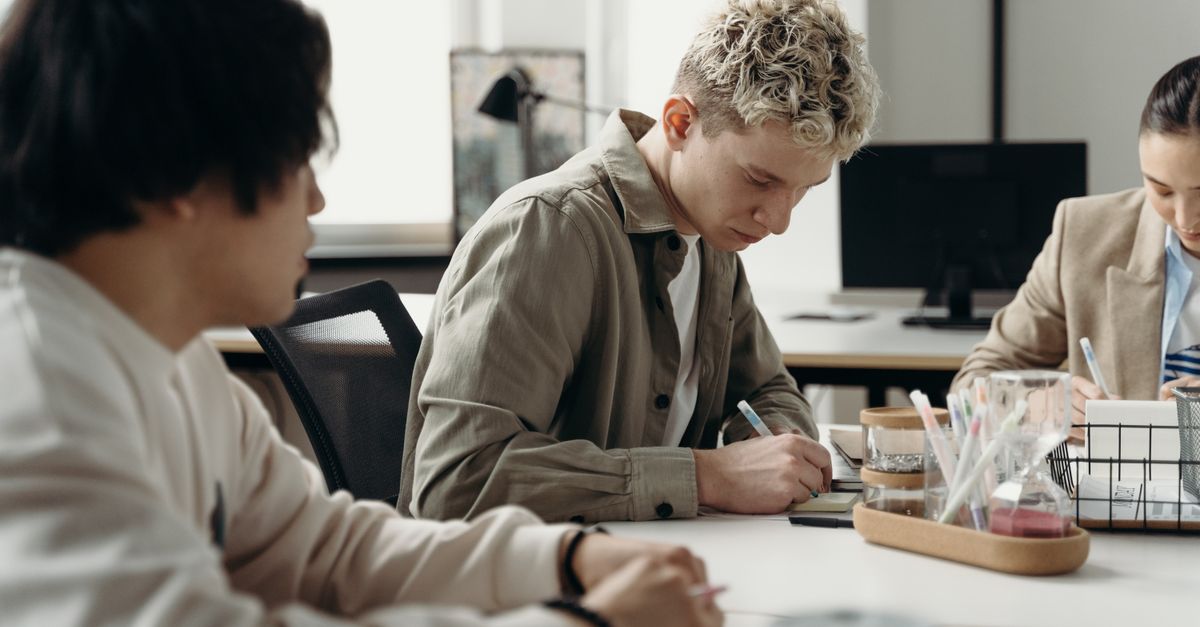 A diverse group of young professionals brainstorming in a contemporary office environment.